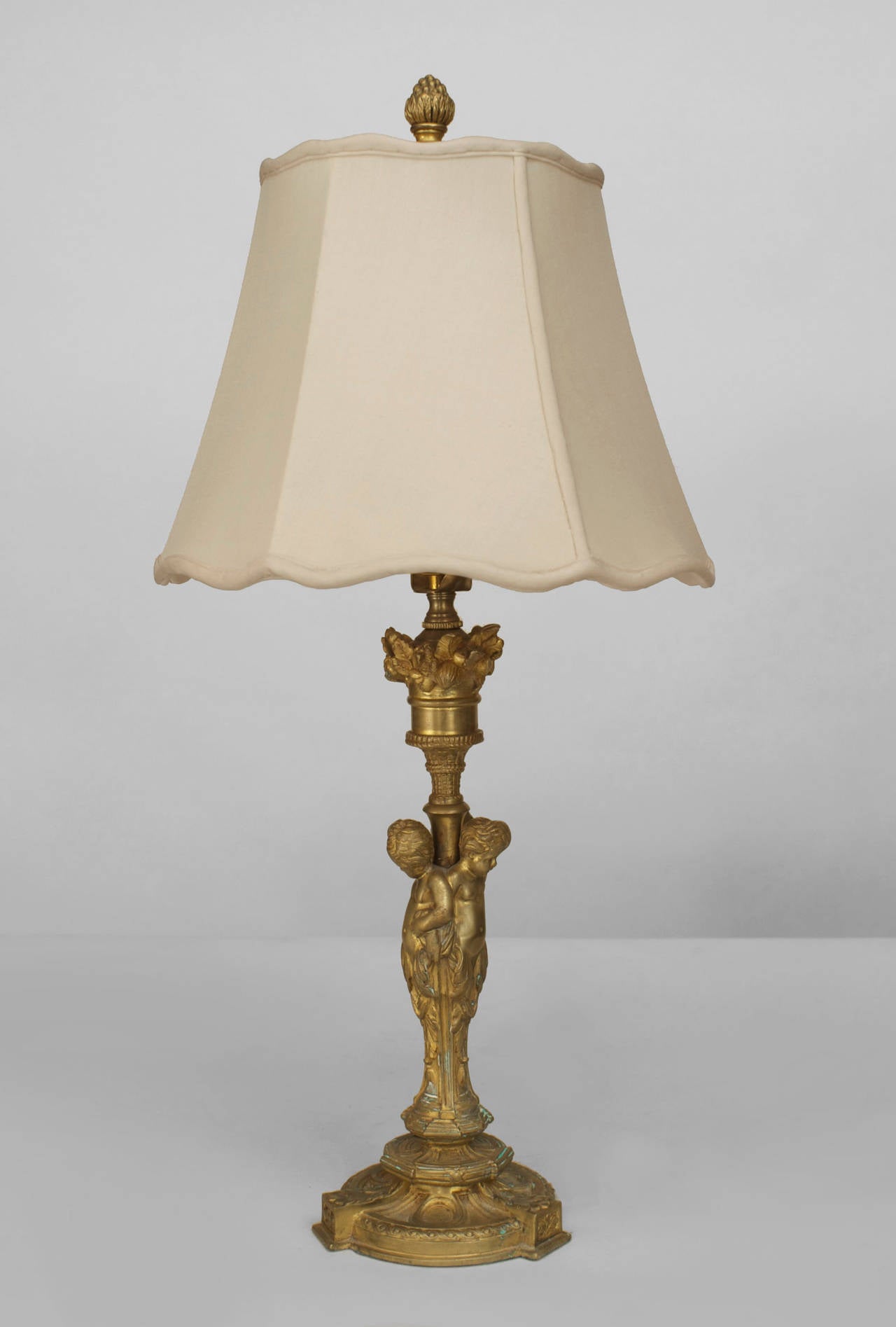 French Louis XV style (19th Cent) bronze candlestick with 3 cupids and a acorn
finial mounted as a lamp.