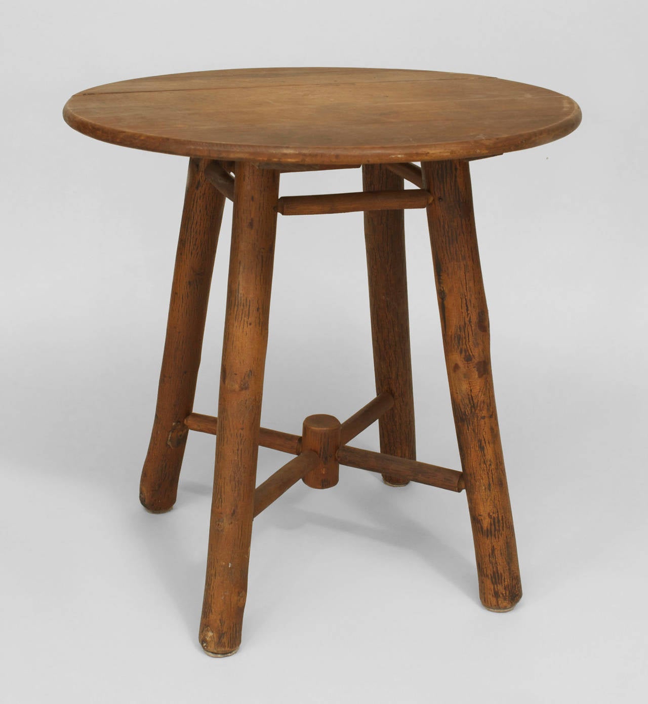 American Rustic Old Hickory round oak top end table with four legs connected by a stretcher having a centered finial.