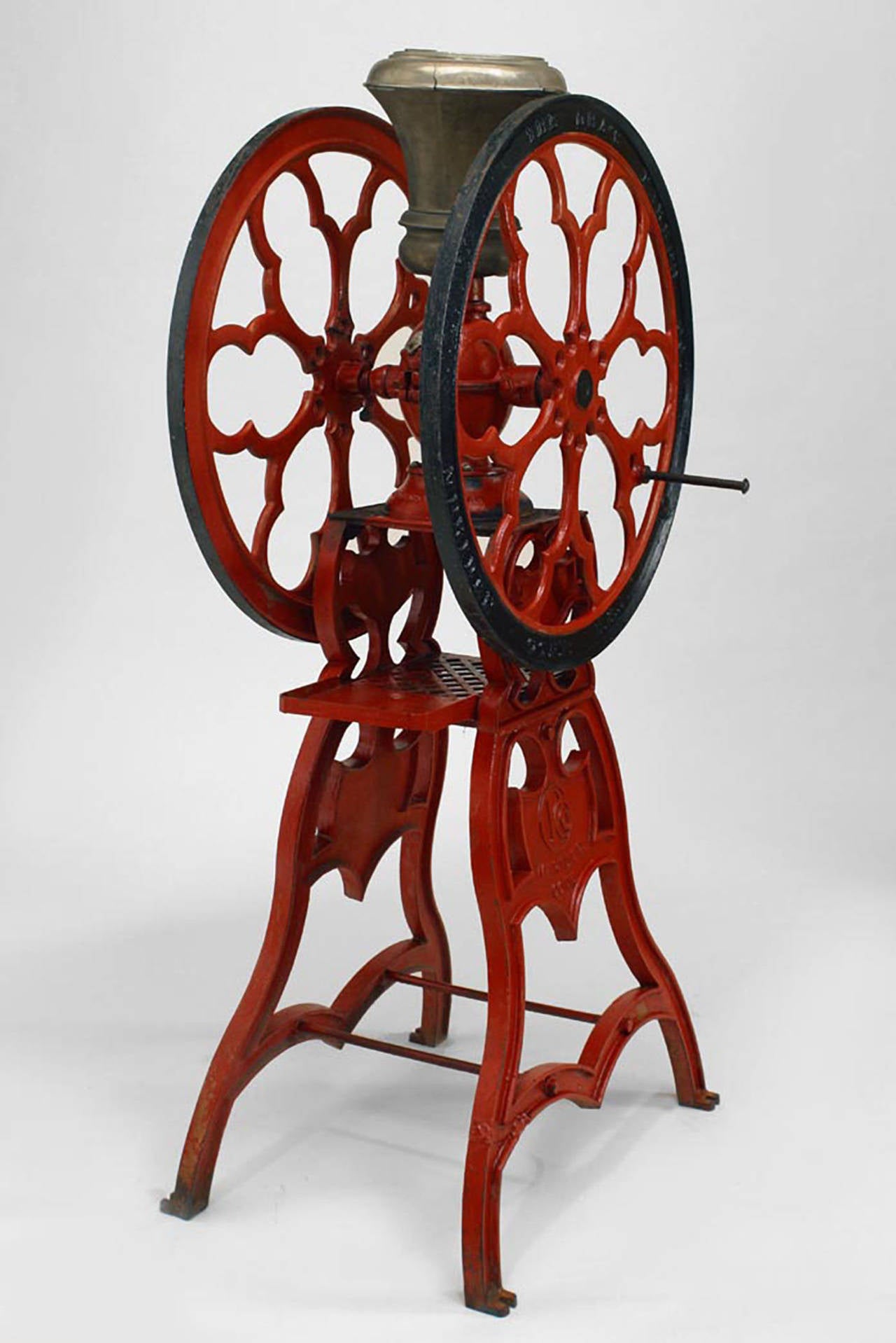 American Victorian red and black painted iron full standing coffee grinder with metal top. (Signed: Cha's. Parker Co. Meriden Conn. USA)
