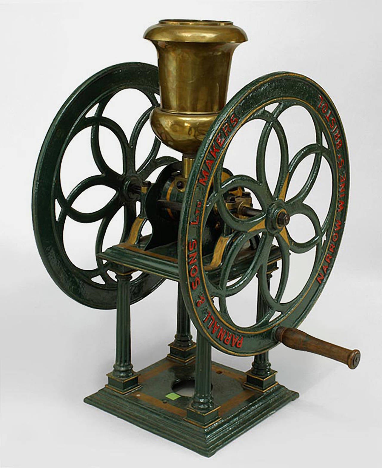 English Victorian green and gold painted iron coffee grinder with brass funnel
and column supports.