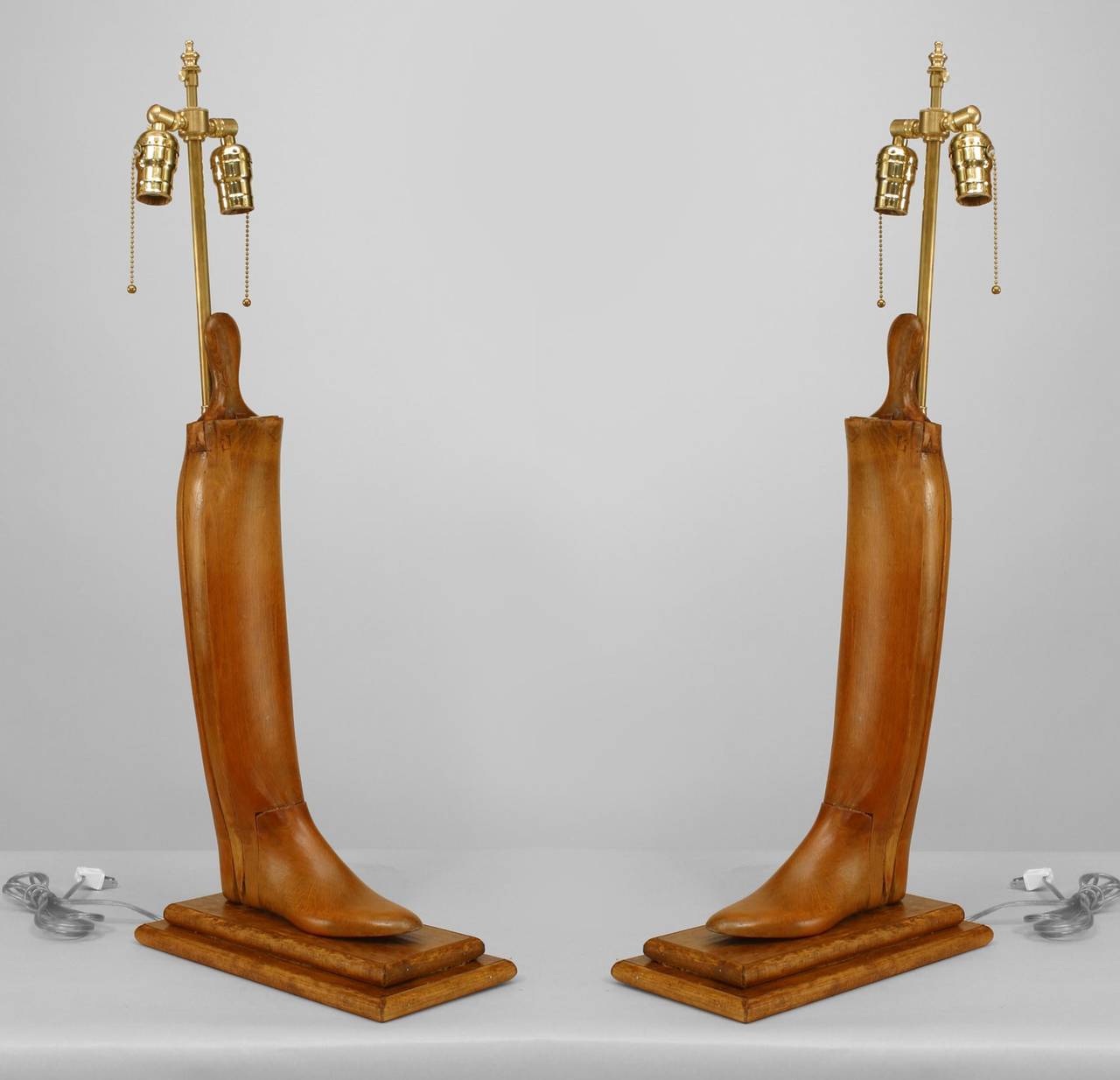 Pair of 19th century English pine boot stretchers mounted on rectangular bases
and wired as lamps.