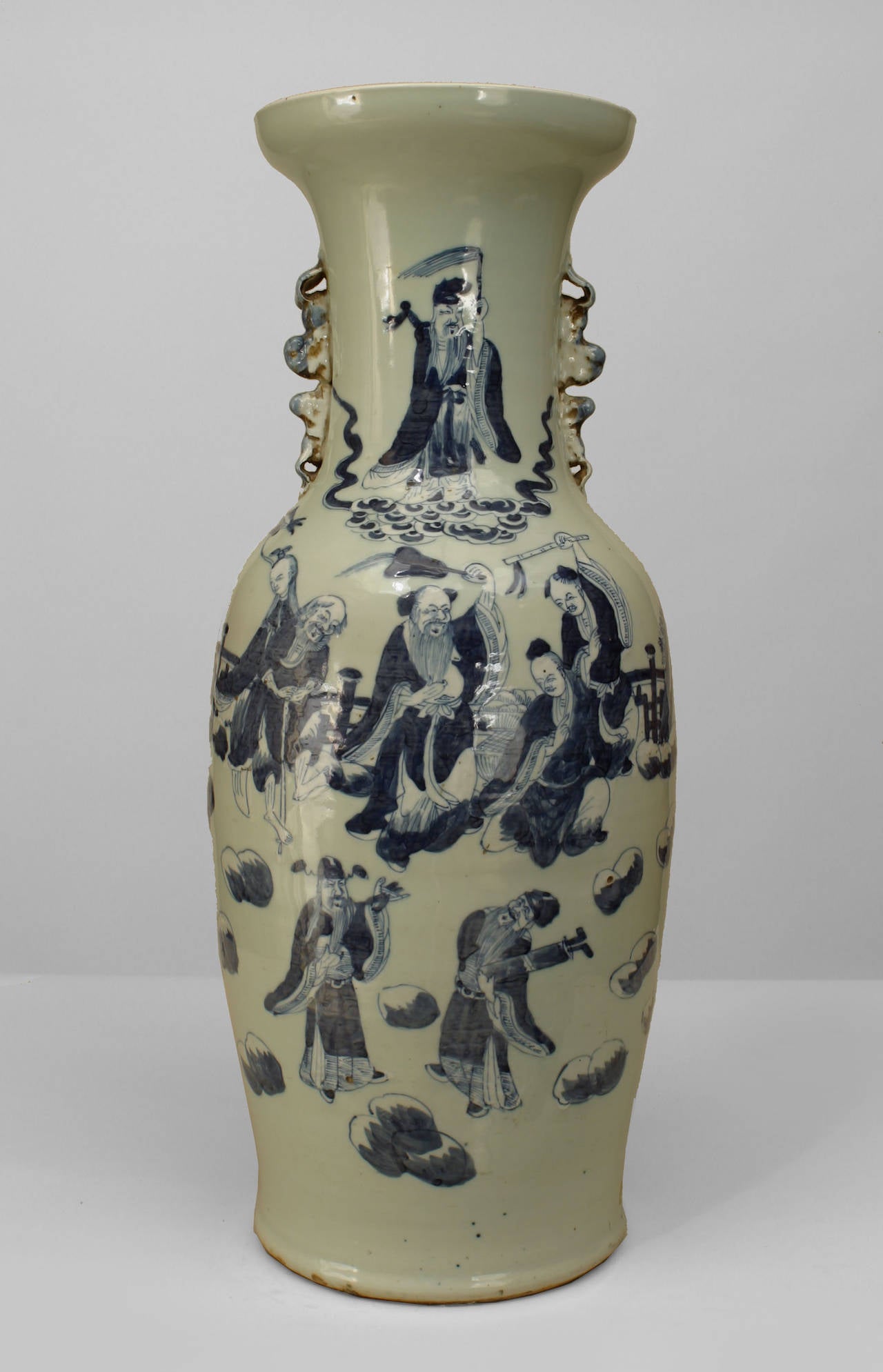 Chinese (20th Cent) porcelain vase with small side handles. The vase is painted  celedon and is decorated with traditional genre scenes in blue paint.