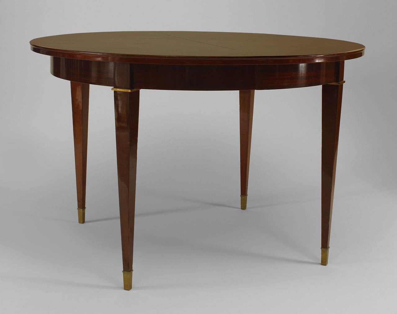 Attributed to Dominique, French 1950's round palisander wood dining table with a sunburst design top supported on 4 square tapered legs with bronze trim and sabot feet.