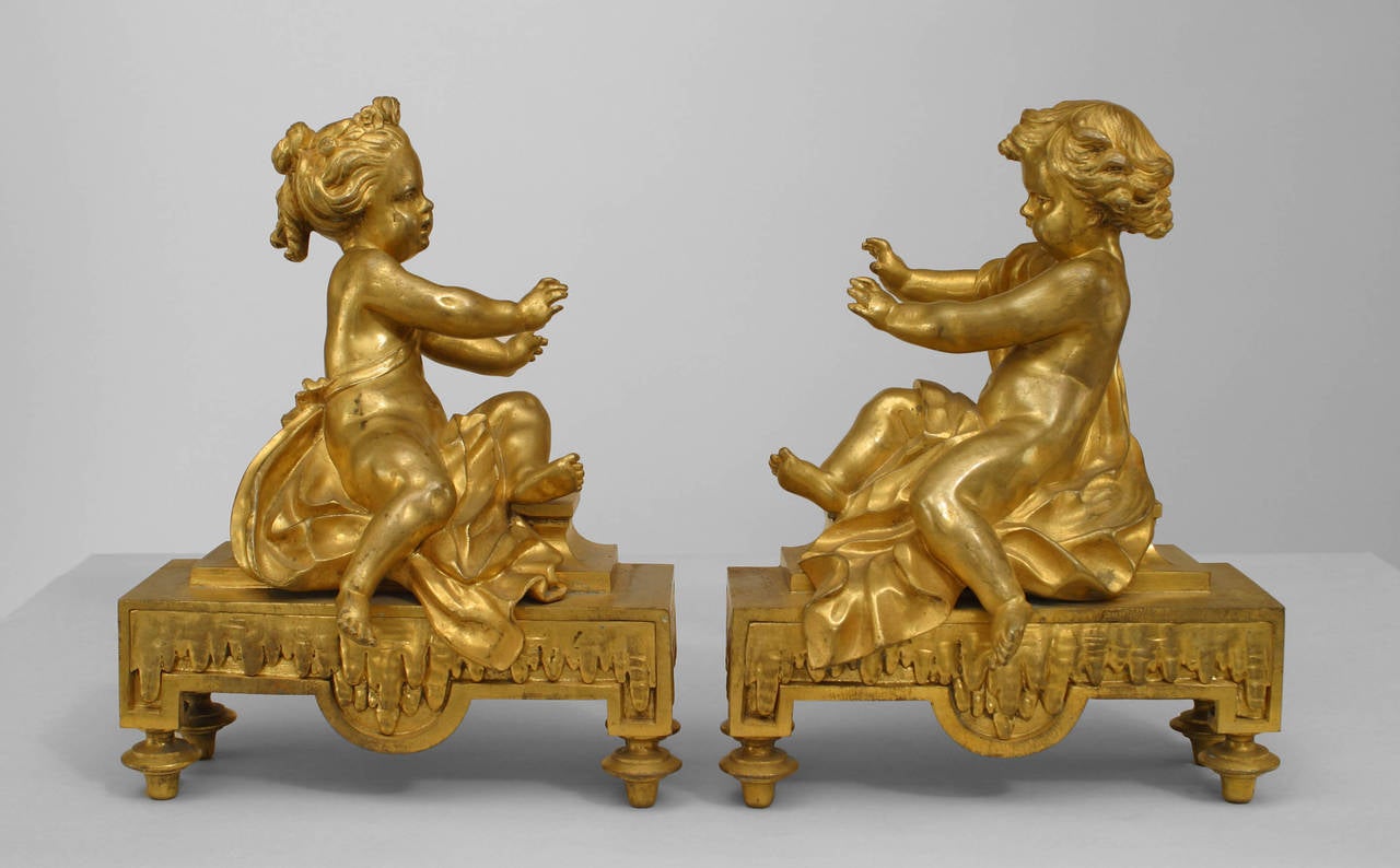 Pair of French Victorian (19th Century) gilt bronze draped cupid figural andirons (chenets) on base. (PRICED AS Pair)
