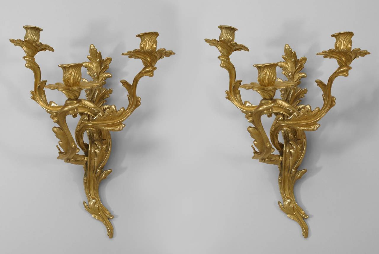 Pair of French Louis XV-style (mid-20th Century) bronze wall sconces with three arms / lights and foliate design form (marked GLO-MAR ARTWORKS, NY)
