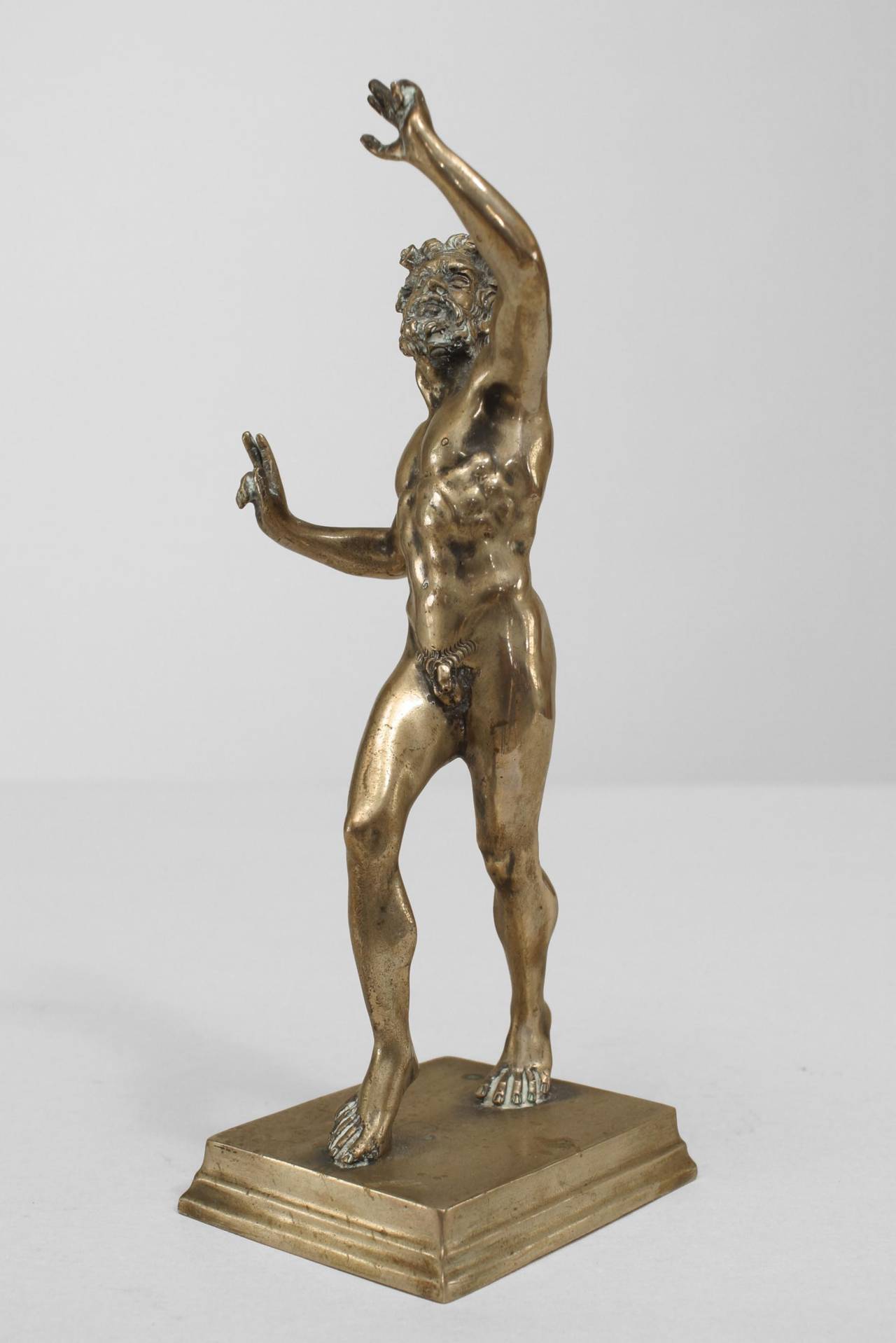 Small silver-plate over bronze nude Greek mythological figure with horns and tail standing on a small tierred base (stamped in corner)
