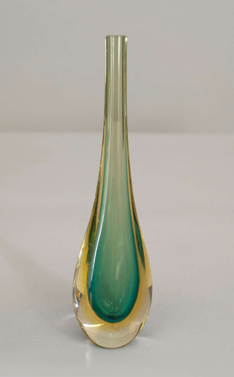 Attributed to mid-century Italian designer Flavio Poli, this 1950's vase is composed of green in amber sommerso Murano glass blown in a teardrop form with a bulbous bottom gracefully transitioning into a narrow, stemlike neck.