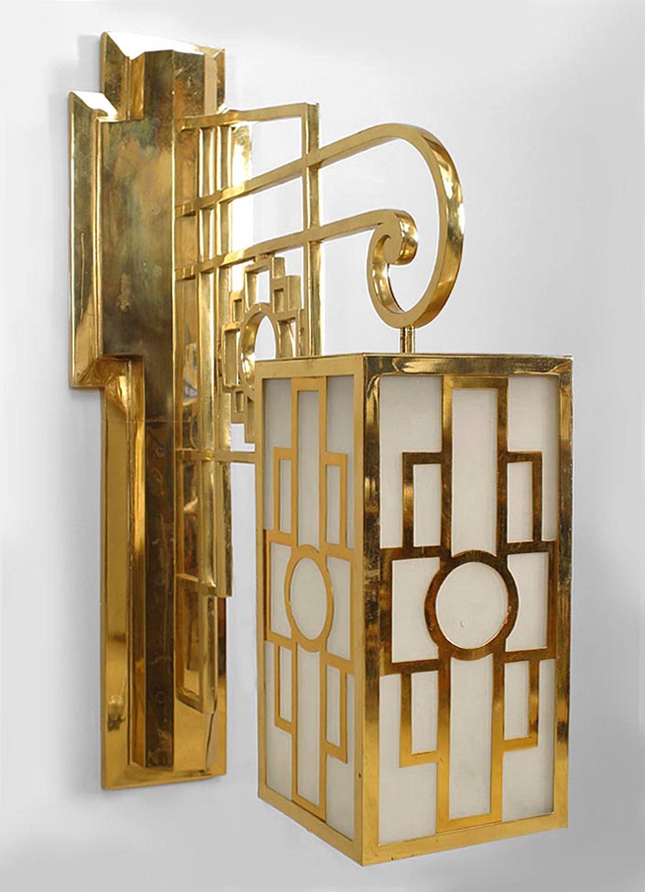 Pair of French Mid-Century (1940s) brass wall sconces with Chinese lattice-design wall brackets supporting four-sided fixtures with frosted glass panels. (PRICED AS Pair).
 