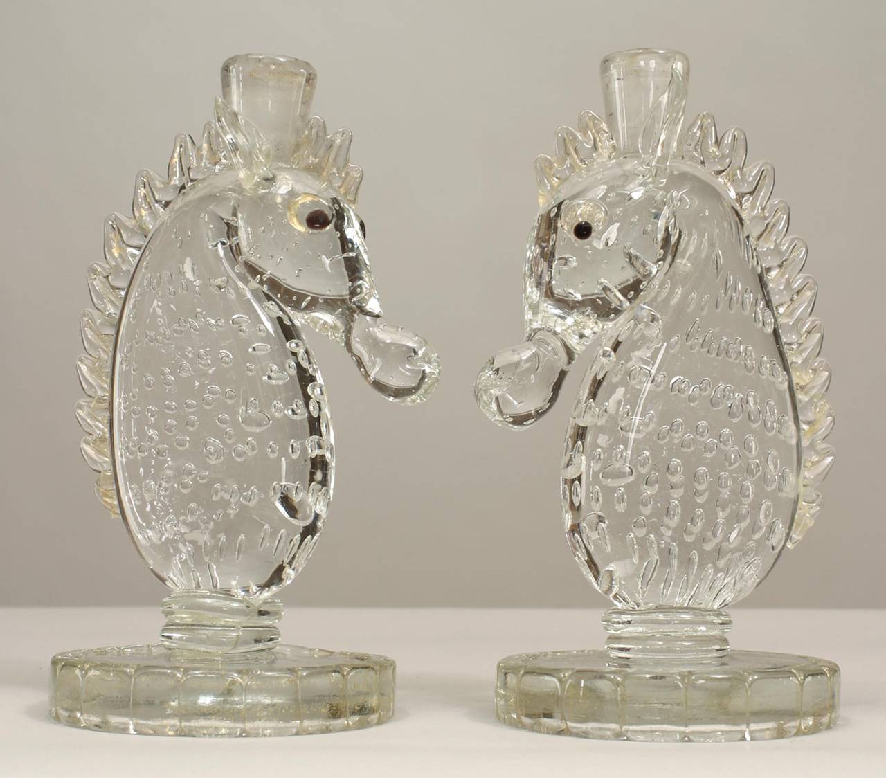Pair of 1940's Italian 1940s Murano glass seahorse design candlesticks on round bases. Signed Barovier e Toso, and numbered 1 and 3 from a limited edition of thirty pieces.