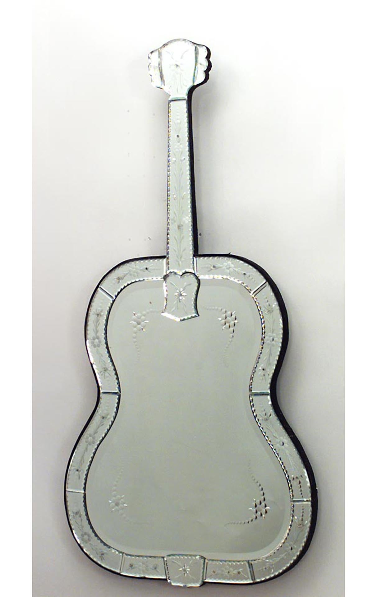 French Mid-Century (1940s) vertical guitar-shaped wall mirror with etched floral design on the border and fingerboard and a black velvet edge.
