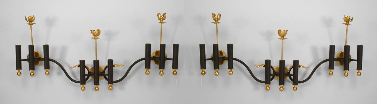 Pair of French Mid-Century (1950's) iron & gilt brass nine light sconces consisting of three groups of three lights finished with brass ball base & single candlelight top and a foliate center. (PRICED AS Pair)
