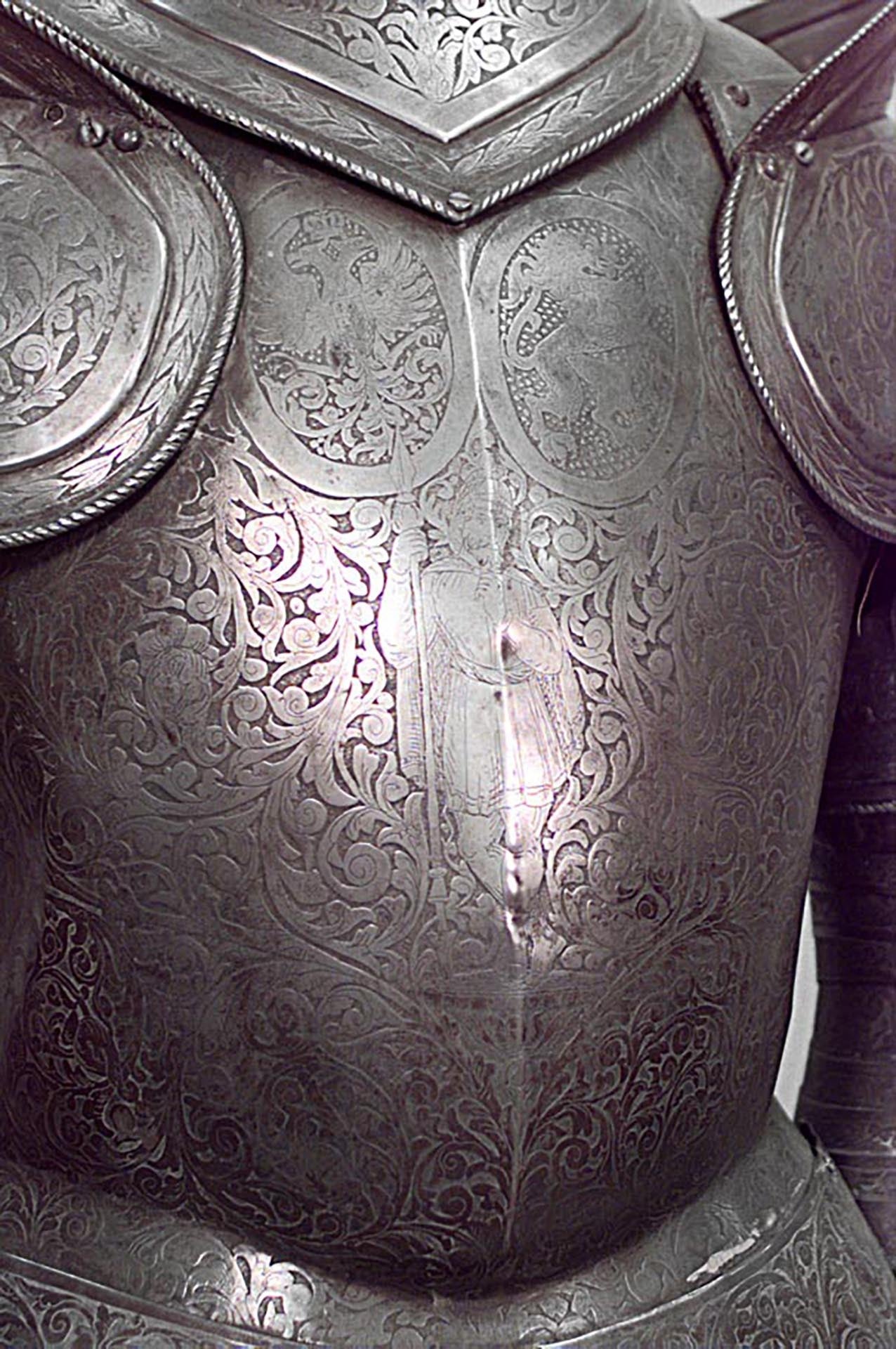 Short Italian Medieval or Renaissance style metal suit of armor with an etched figure on its breast plate.