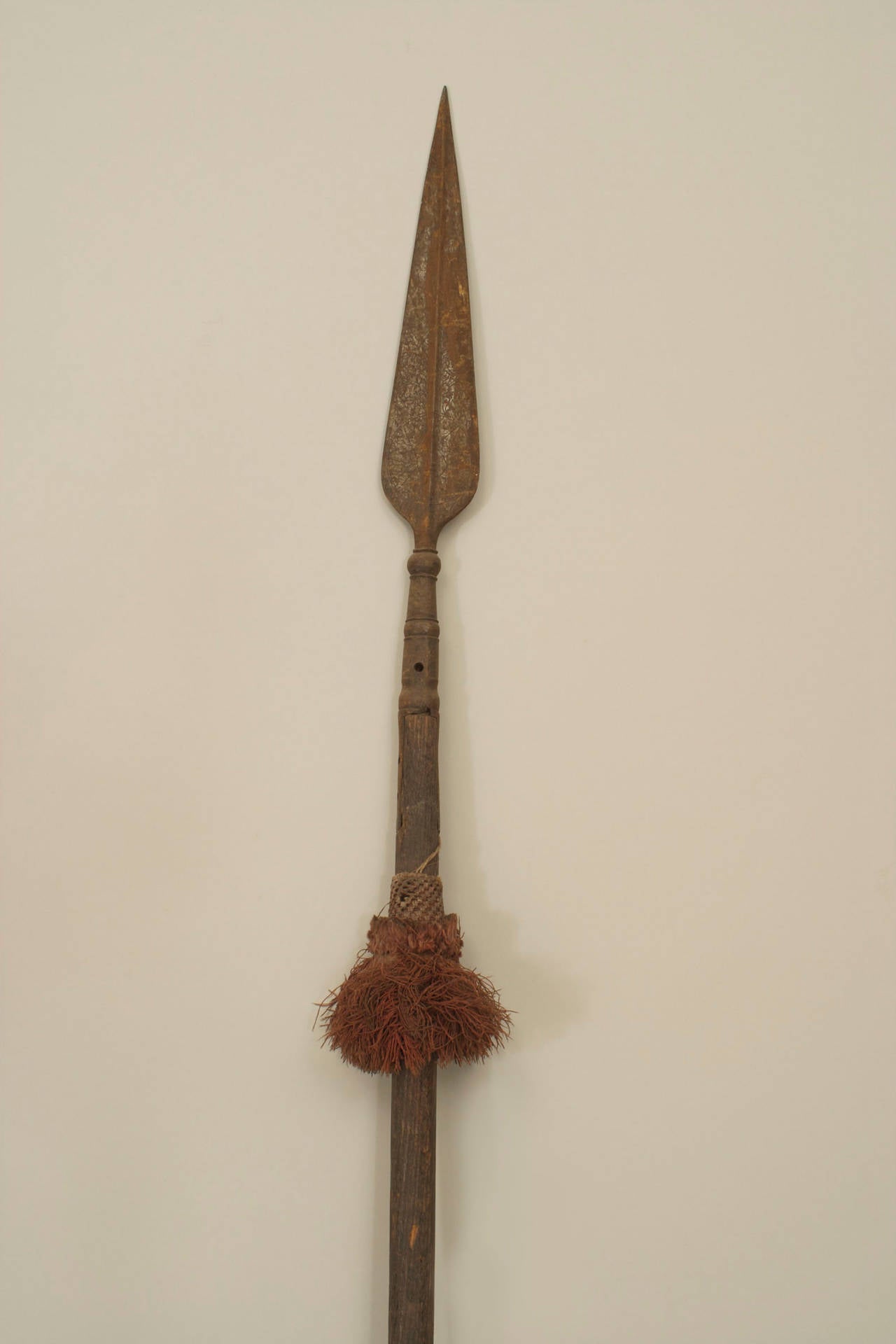 English Renaissance-style spear with wood shaft and etched iron blade with tassel.
