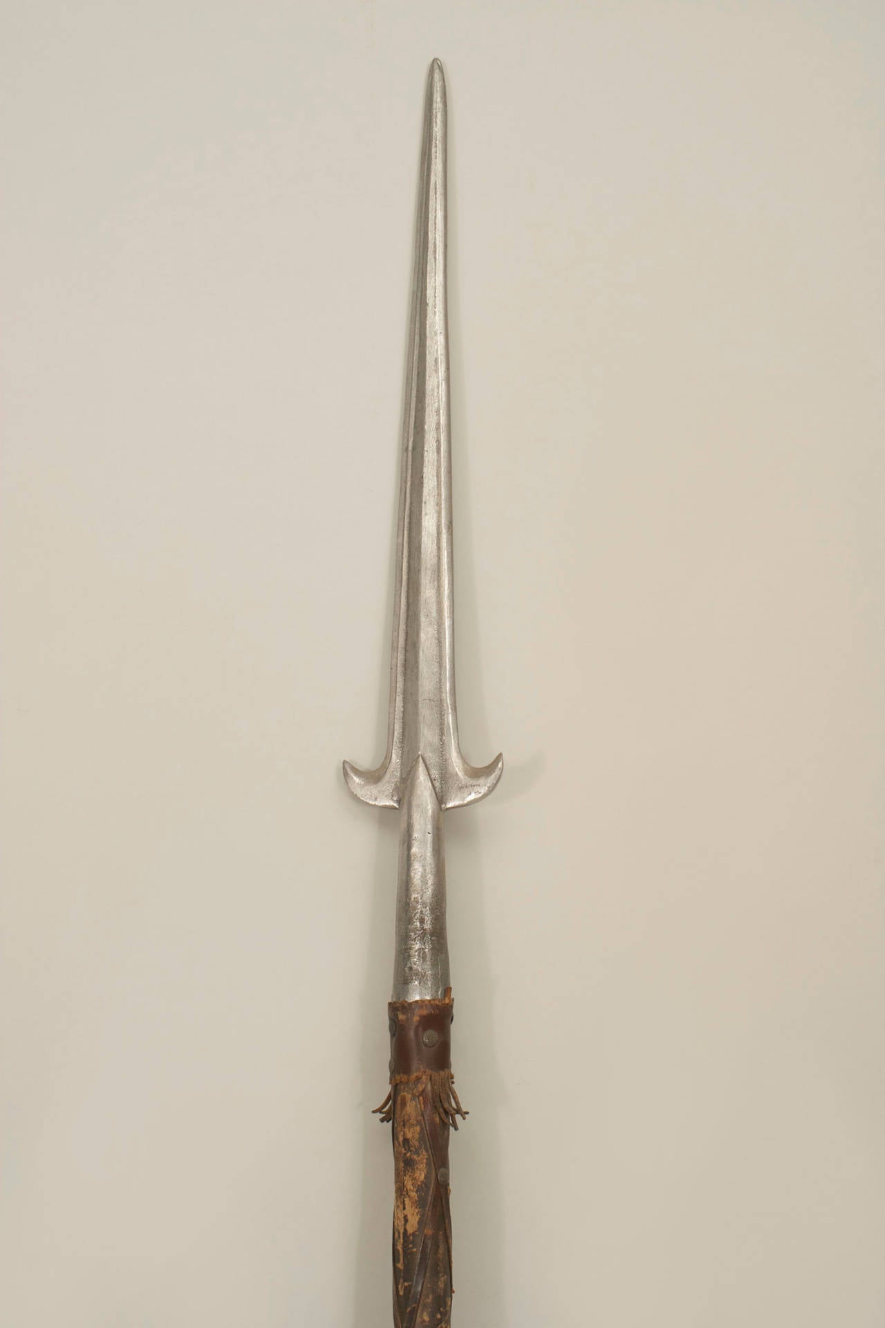 English Renaissance style Halbert spear with a crossed leather-covered shaft
and polished steel blade.