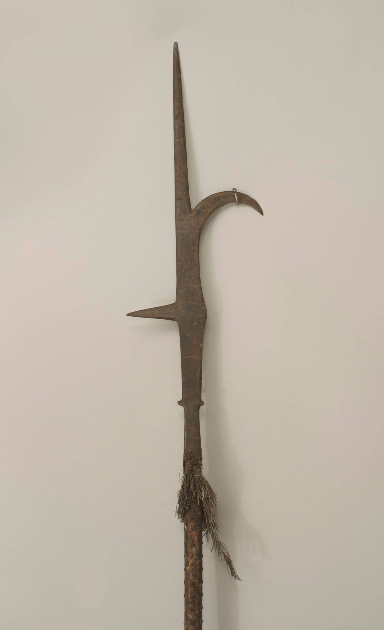 English Renaissance-style halberd spear with wooden shaft with tassel and nail heads and a 34¬Ω-inch iron blade with hook.
