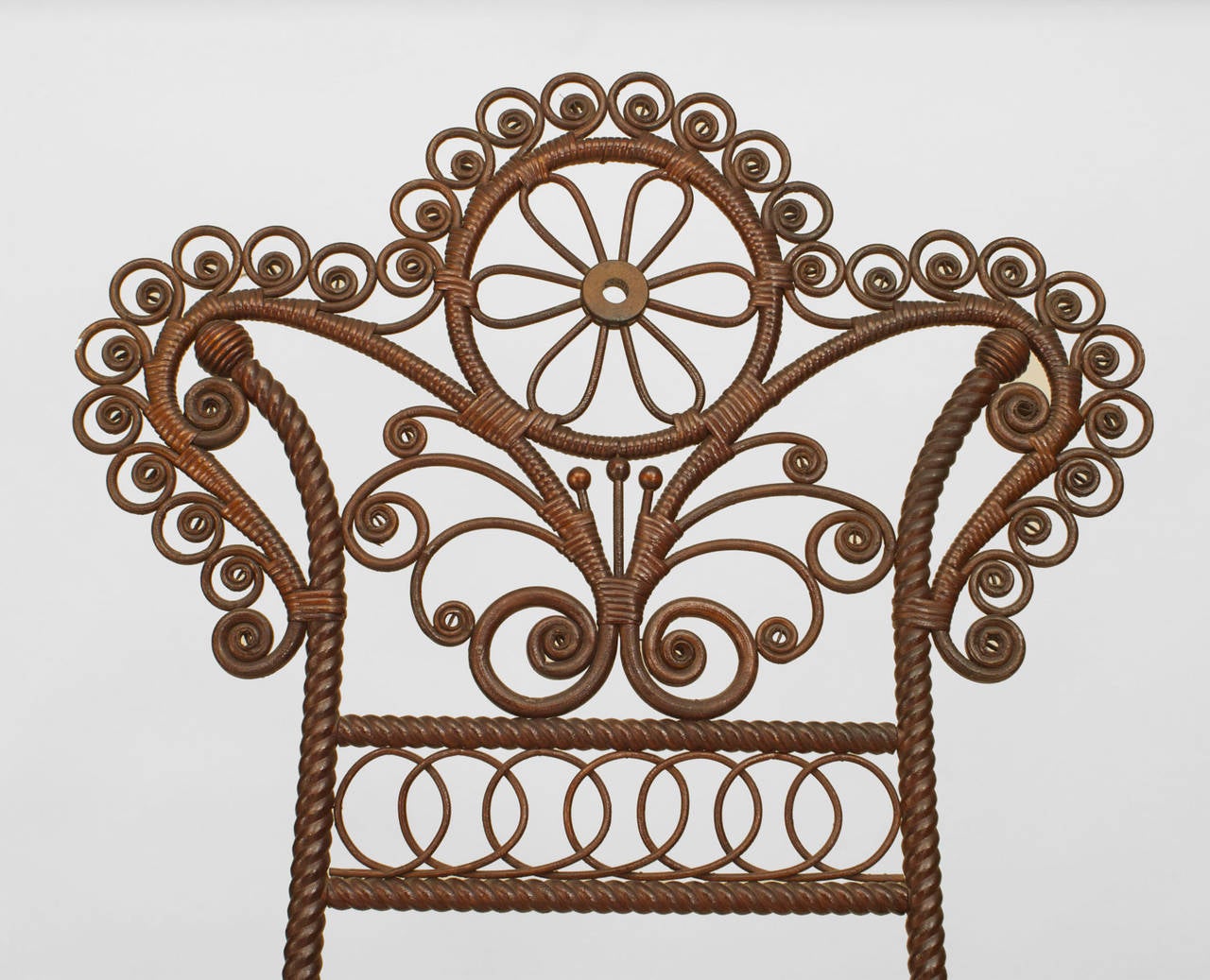 American Victorian dark stained natural wicker & spool wood easel stand with shaped and scroll pediment top and bottom with a Pair of iron filigree supports. (att: HEYWOOD WAKEFIELD)
