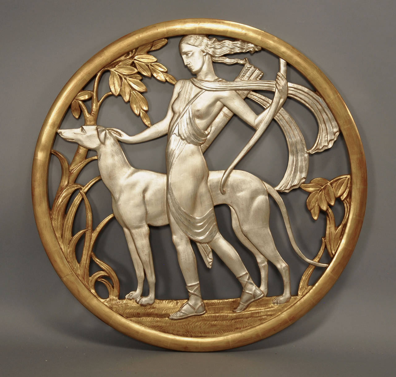 Art Deco round gilt and silver gilt filigree wall plaque showing the goddess Diana hunting with her dog.