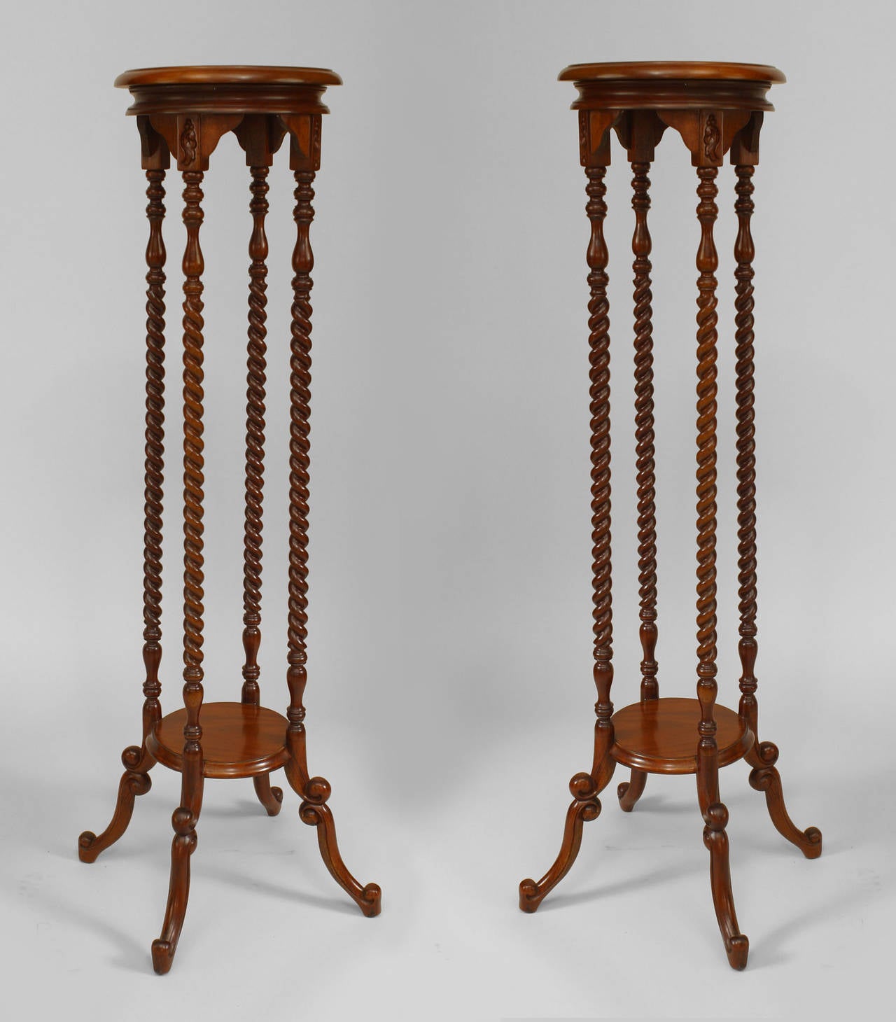 Pair of English pedestals with four swirl design columns and a bottom shelf.