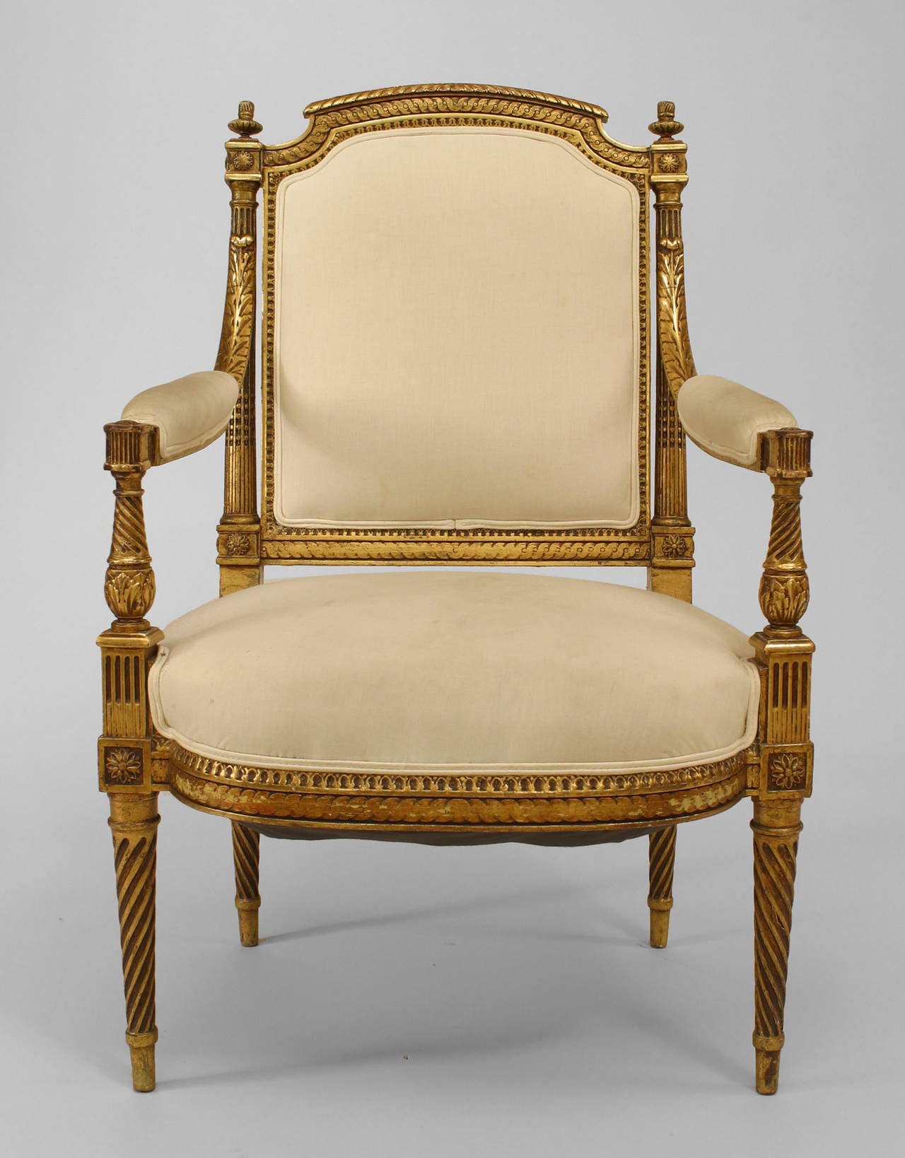 Pair of 19th century French Louis XVI style gilt carved open arm chairs with
upholstered seats and backs and carved swirl design legs.
