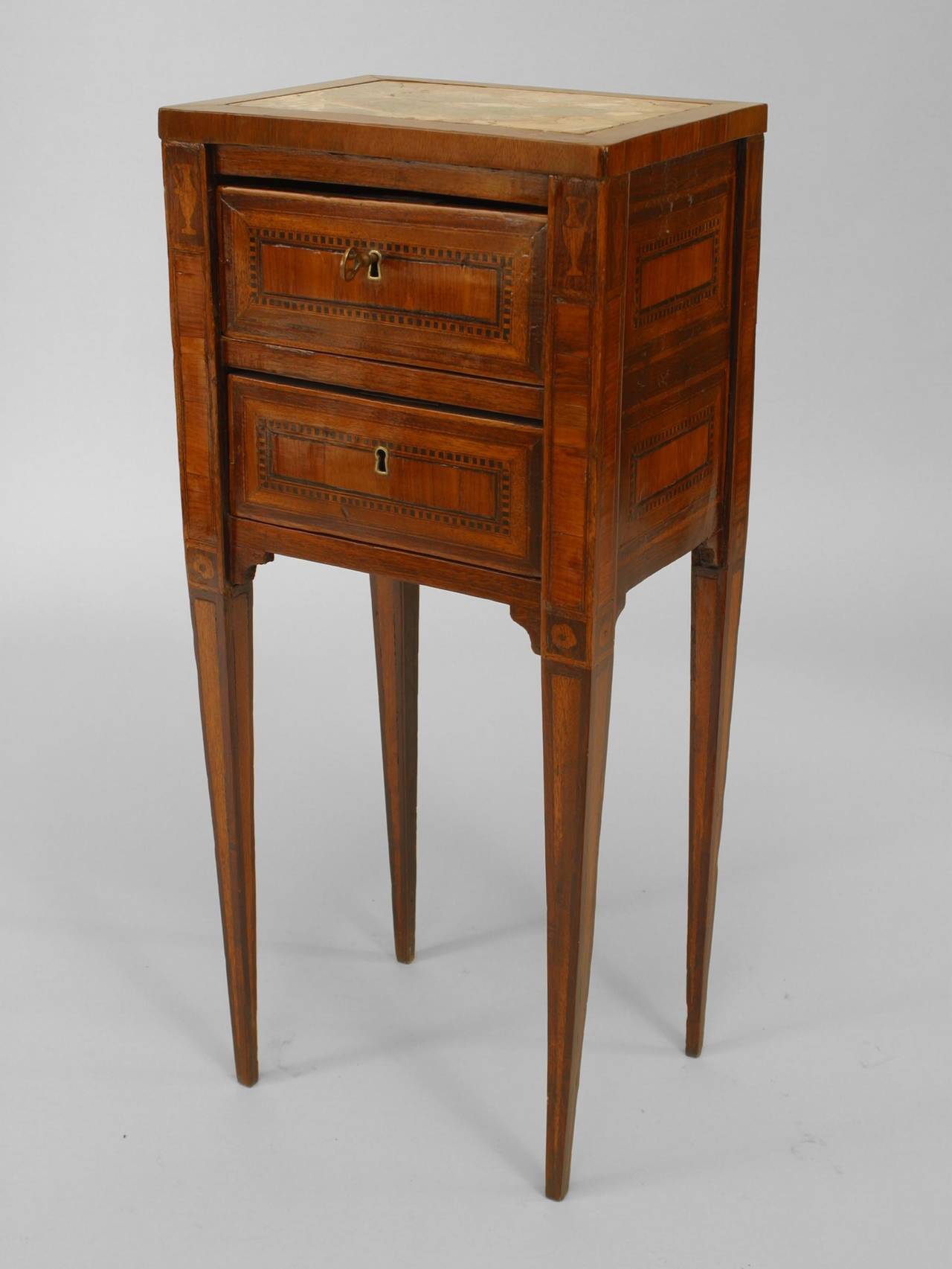 18th century Italian Neoclassical mahogany 2 drawer end table with inlaid
trim and an inset marble top above four tall tapered square legs.
