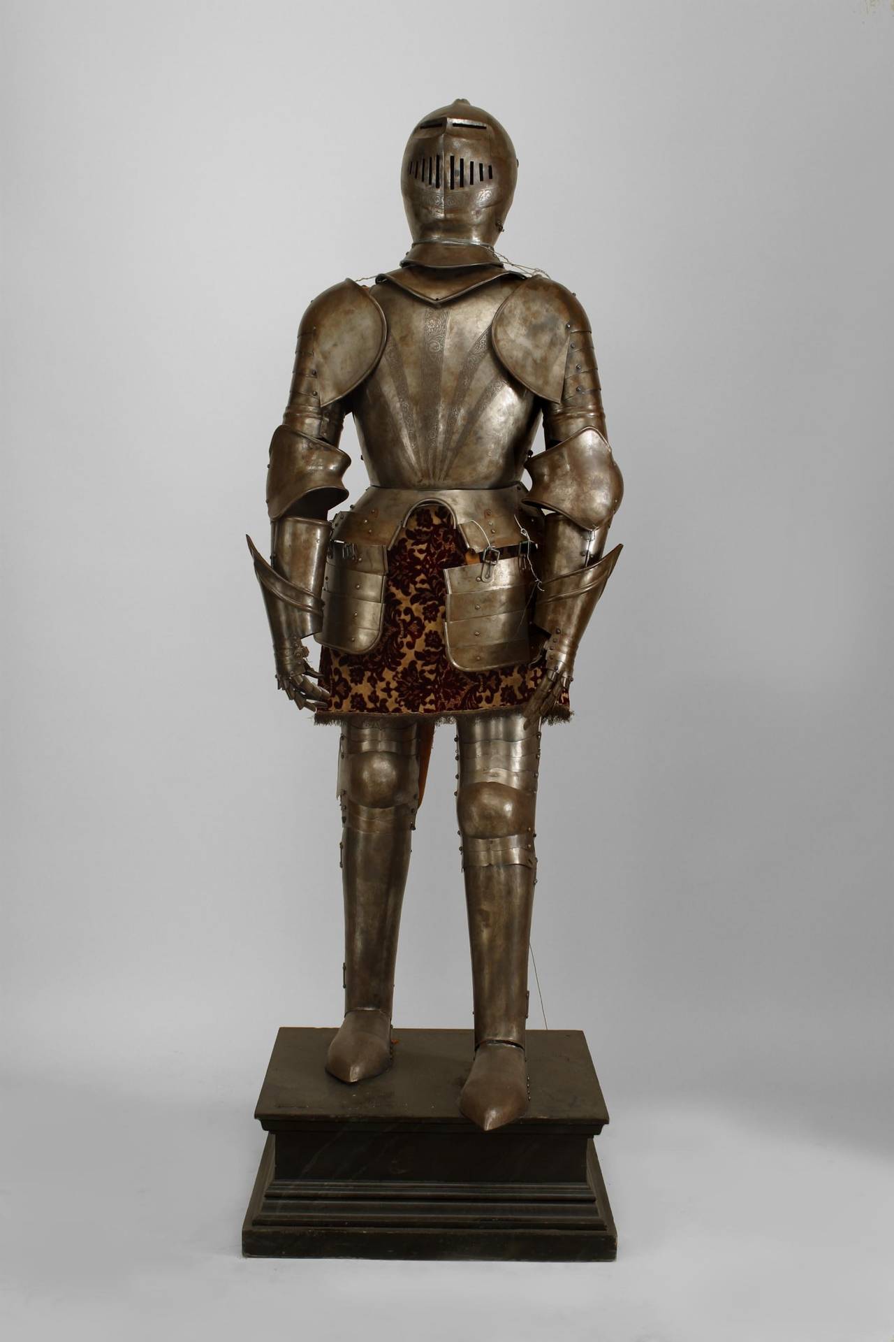 Italian Medieval / Renaissance style metal life size suit of armor with etched
sunburst breast plate.