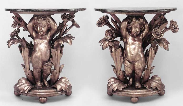 Pair of French Louis XV-style (19th Century) gilt rococo carved cupid base half round console tables with rouge marble tops. (Cupids face left and right) (PRICED AS Pair)

