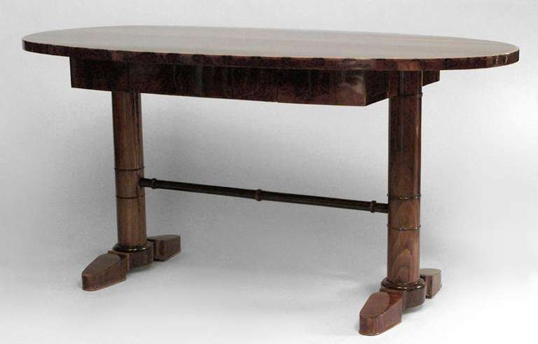 Austrian Biedermeier walnut table desk with an oval top and single drawer supported by a column pedestal base.