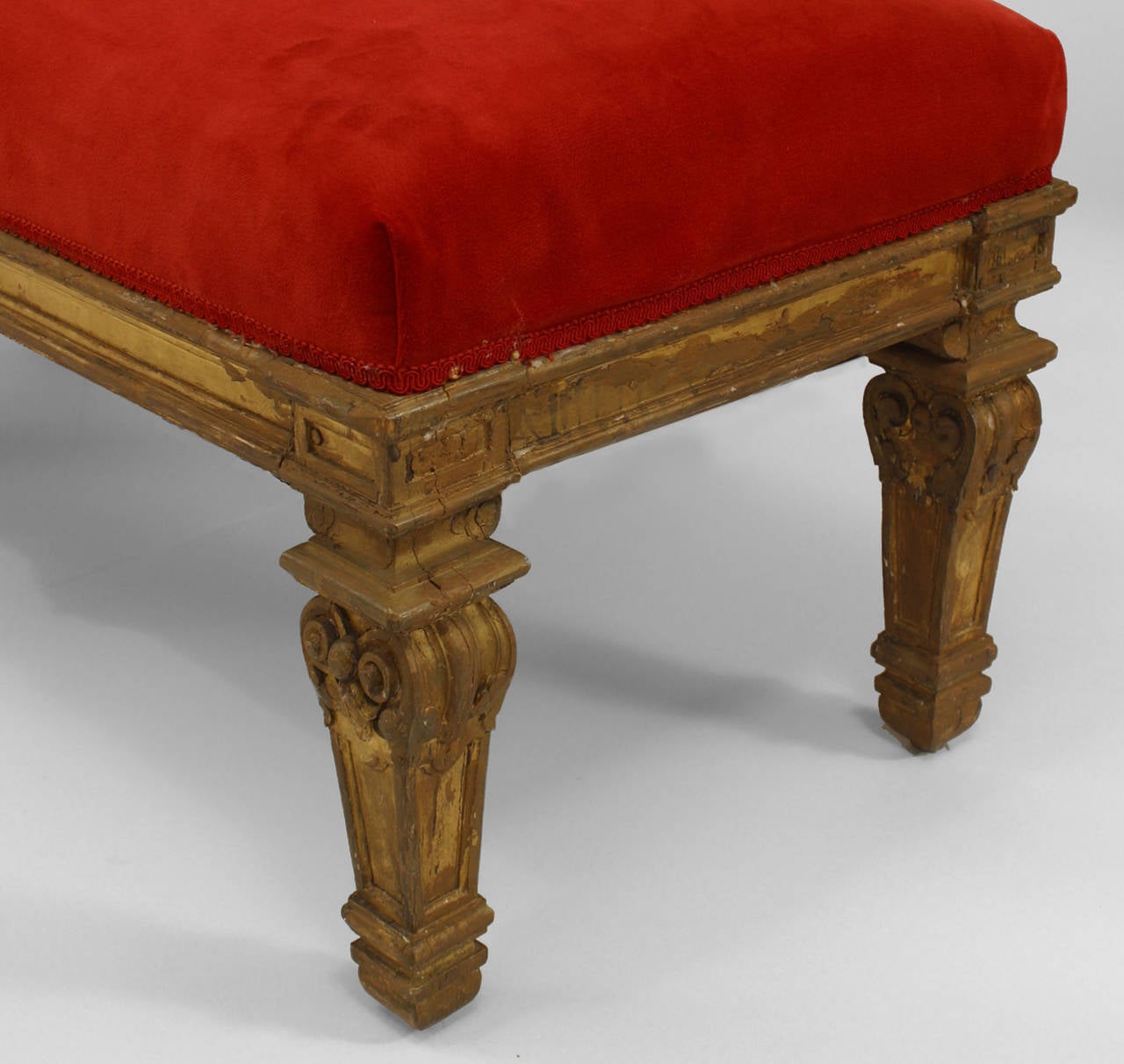 Pair of 19th century French Louis XIV style carved giltwood benches with six legs.
And a red velvet upholstered seat.