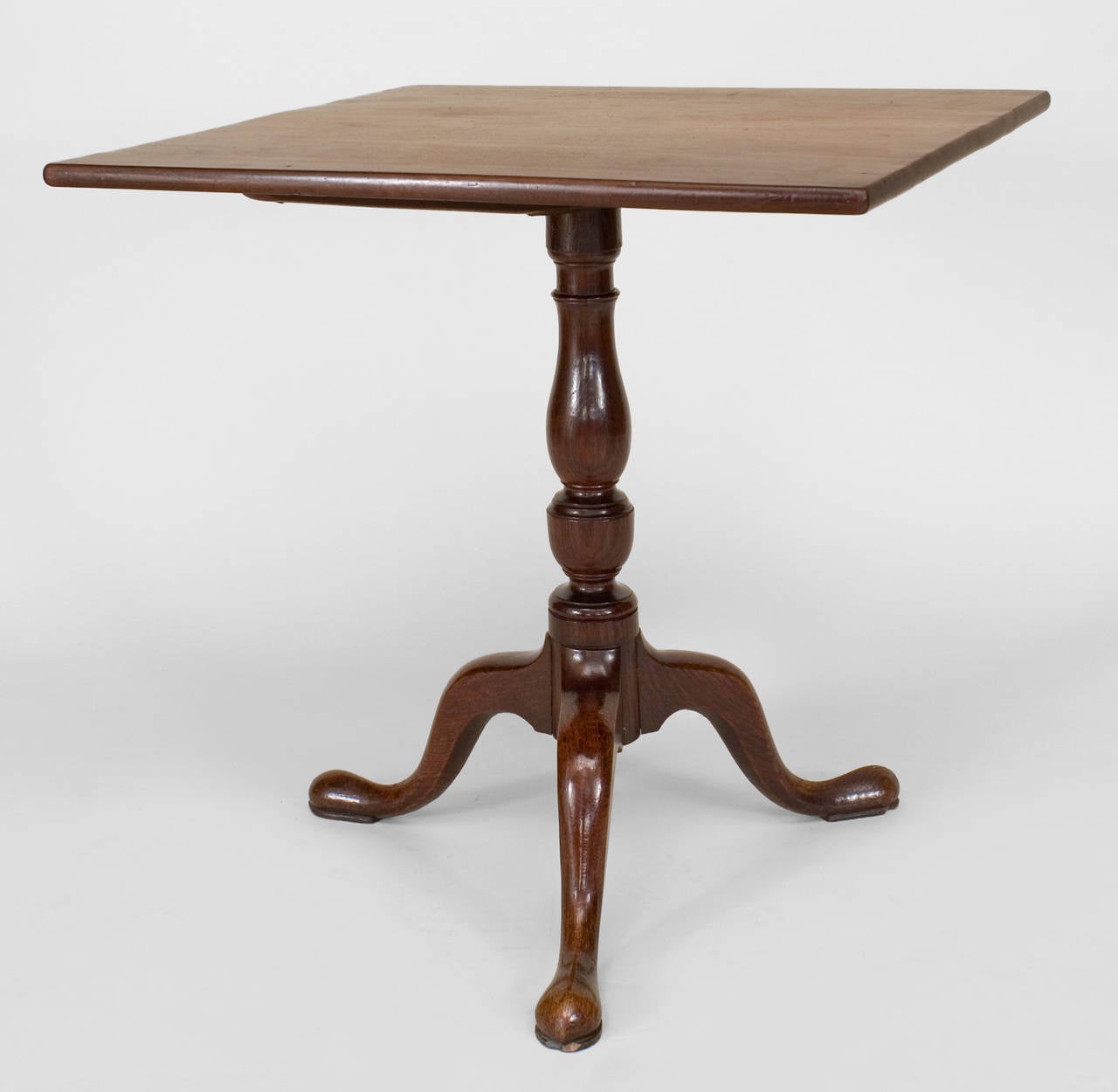 English Queen Anne-style (18th Century) mahogany pedestal base tilt top end table with a square top supported on 3 legs.

