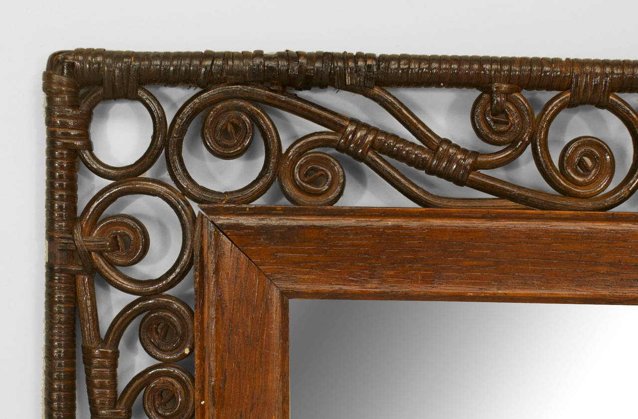 Attributed to Heywood-Wakefield, a 19th century American dark stained natural wicker rectangular wall mirror with a filigree scroll design frame.