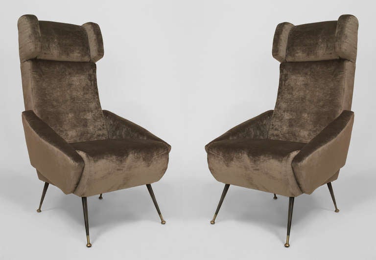 Pair of Italian 1960s grey velvet upholstered stylized wing back armchairs standing on ebonized and brass tubular metal legs.
 