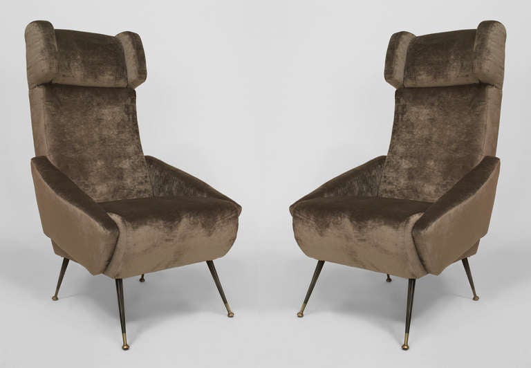 Pair of Italian 1960s grey velvet upholstered stylized wing back armchairs standing on ebonized and brass tubular metal legs.
 