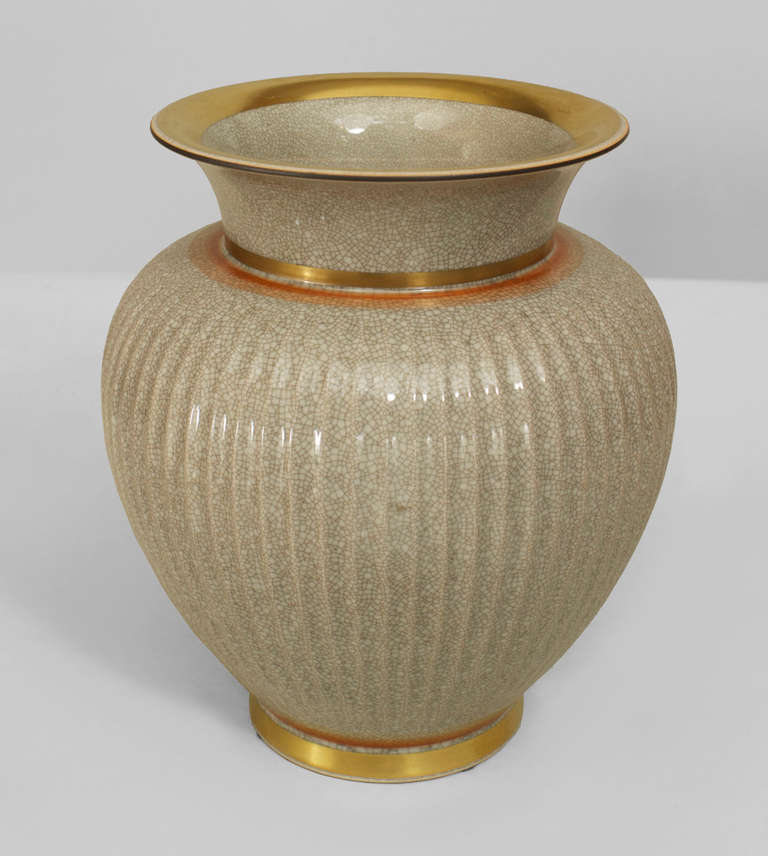 Signed Royal Copenhagen, this 1950's Danish vase is composed of fluted, crackled grey porcelain with gold and orange accents at the base and rim.