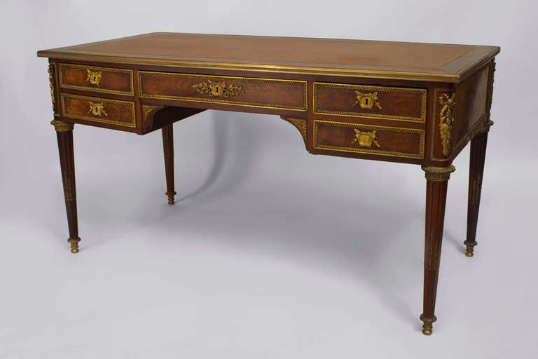 French Louis XVI style (late 19th Century) mahogany and bronze trimmed desk with 2 Pair of drawers centering a single drawer with a brown leather inset top.
