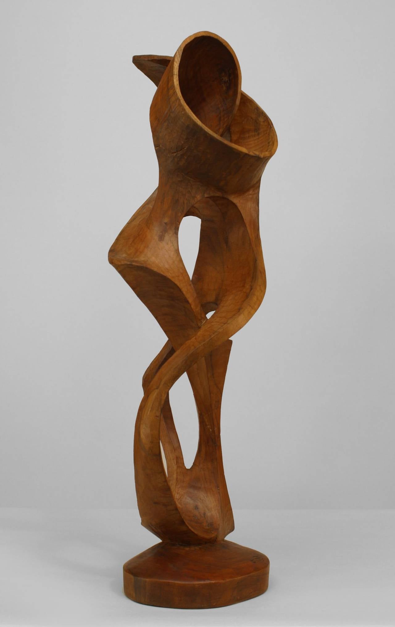 Zeitgenössische abstrakte Skulptur aus Ahorn (Ambrosia-Holz) in Form einer vertikalen Schnitzerei mit offenem Design, umgeben von Schnecken, die von einem massiven Sockel ausgehen.
