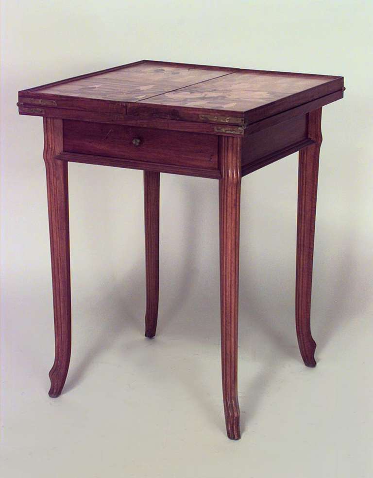 French Art Nouveau game table signed by Emile Galle. The table is composed of walnut inlaid with floral and card suite designs and features a square folding top with a single drawer above four legs with angled feet.