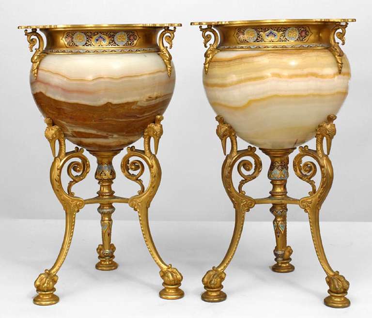 Pair of 19th Century French mounted urns. The round urns are composed of onyx with bronze dore and cloisonne enamel rims and bases with three legs cast with bird heads and feet.