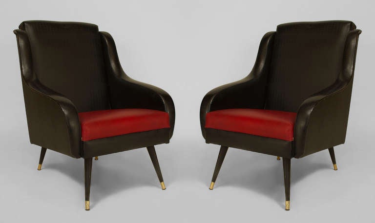 Pair of French Mid-Century (1950s) bergeres Armchairs upholstered in a black faux alligator with a faux red leather seat supported on tapered tubular legs with brass sabots (PRICED AS Pair)
