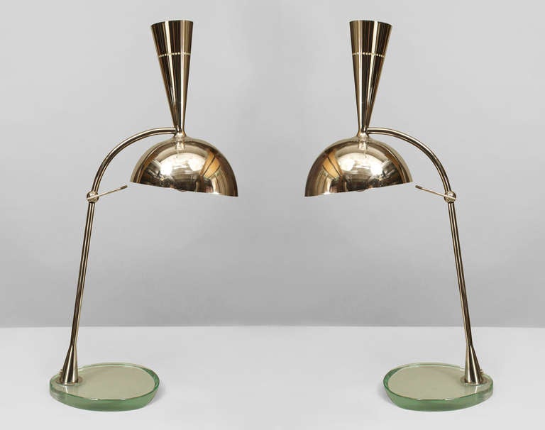 Pair of 2008 Italian chrome table lamps by Roberto Rida with adjustable dome shades having an uplight top resting on a freeform glass base.
