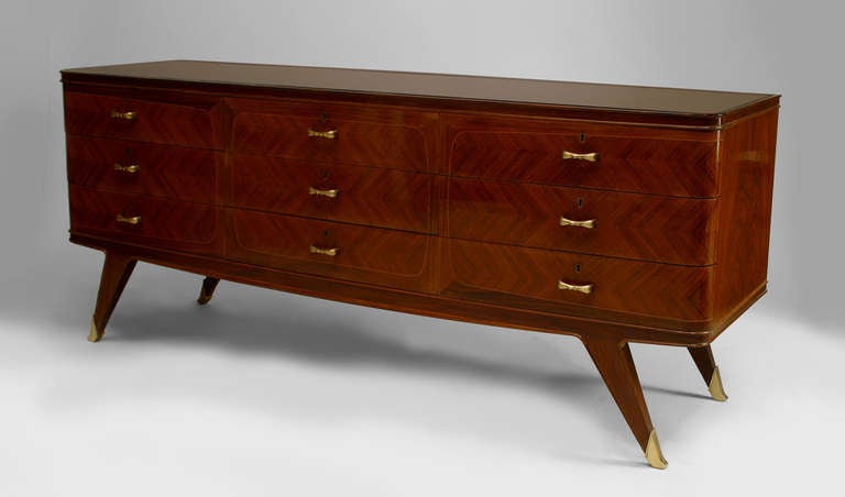 French Art Deco rosewood veneered chest with nine drawers finished with brass handles above four splayed legs with brass sabot feet.