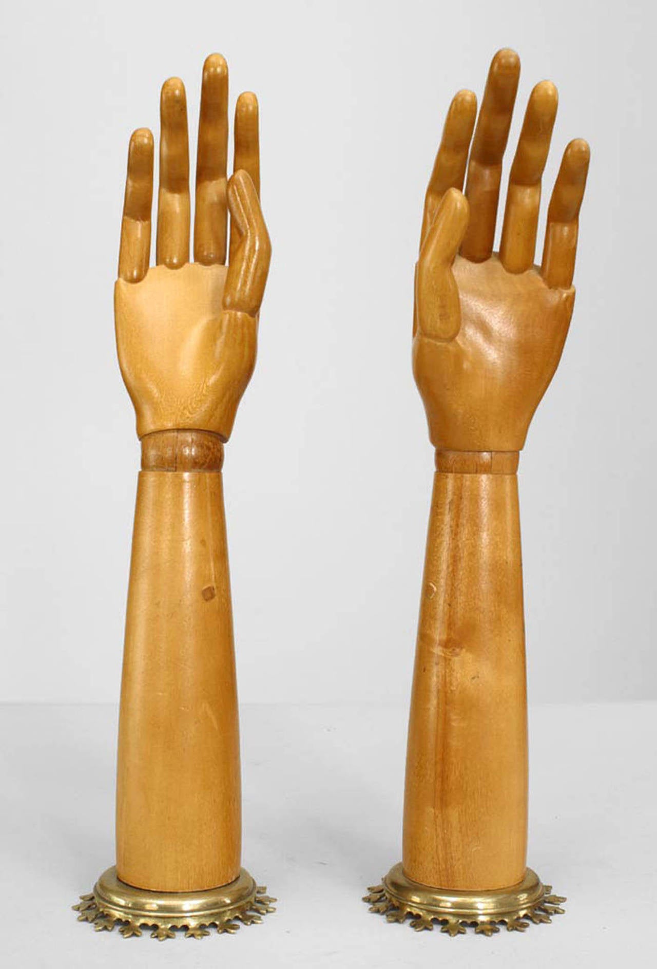 Pair of 19th century English articulated pine hands on brass bases.