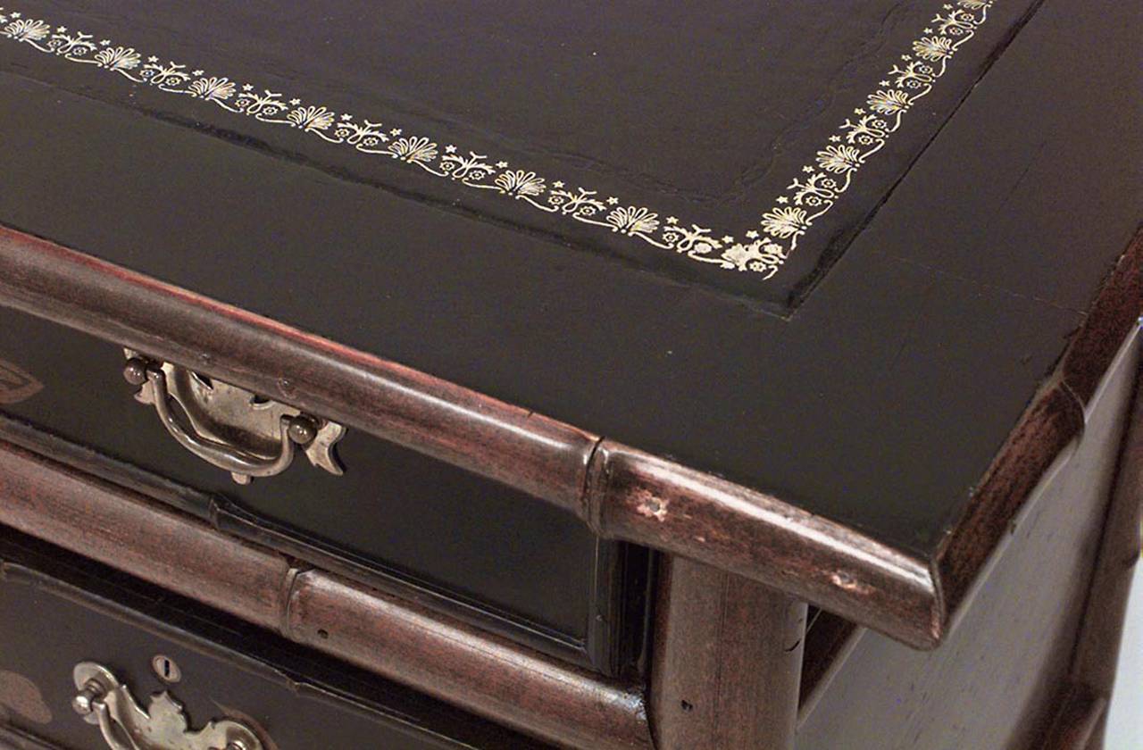 19th century English and black lacquered chinoiserie decorated desk with a black leather top and drawers on one side.