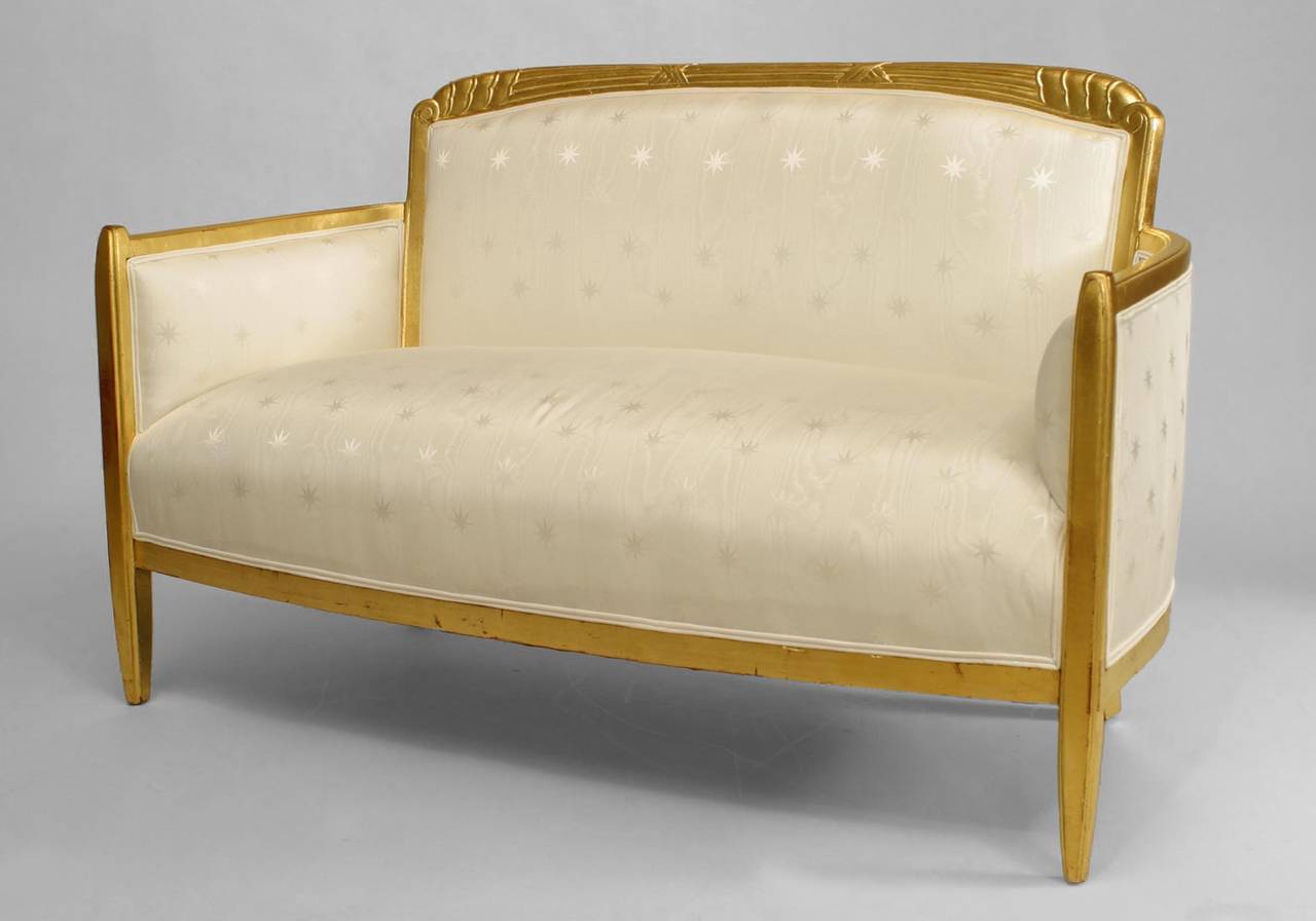 Set of 3 French Art Deco gilt living room / salon set with low back design and carved scalloped & fluted design on back with white star upholstery. (Settee, 2 armchairs)
