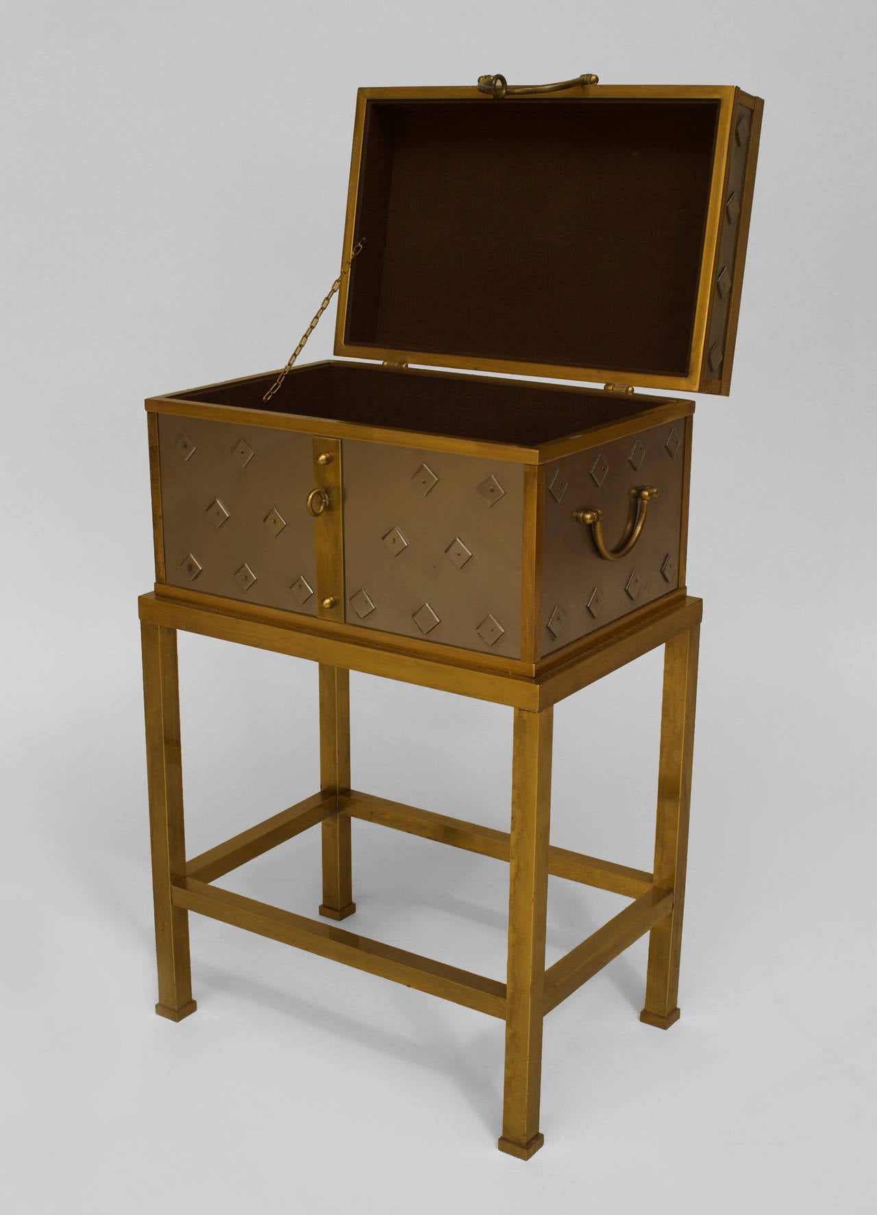 Italian silvered and brass trimmed box or chest with side handles and an applied diamond design resting on a brass base.