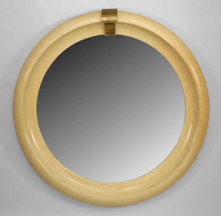 American Mid-Century Modern large round wall mirror mounted in a bevelled frame veneered in a small, faux ivory brick design.