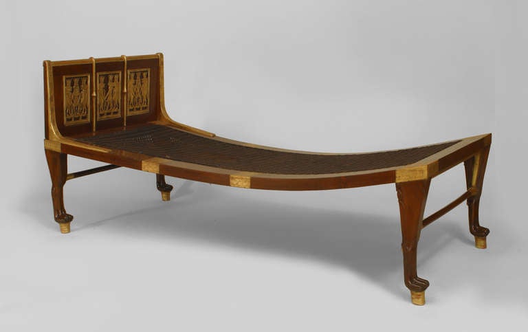 English Egyptian Revival style mahogany and gilt carved and trimmed day bed or recamier featuring classical Egyptian figures and a woven seat