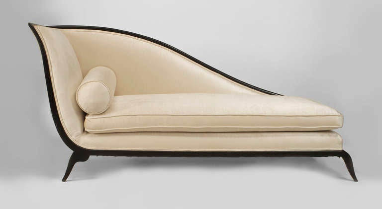 French Art Deco black lacquered sleigh back recamier featuring four curved legs and an off-white upholstered seat and back with additional cushions.