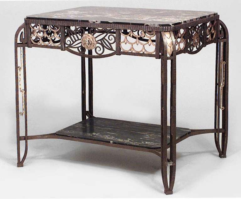 Attributed to Edgar Brandt, this rectangular steel Art Deco center table features swag and scroll designs, as well as a black marble top and shelf.