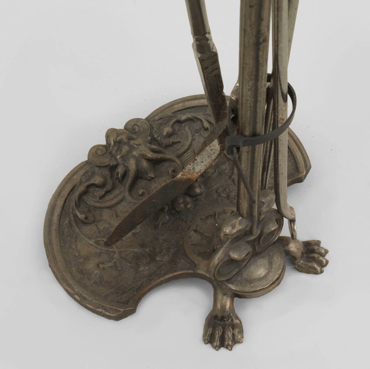 Set of 3 Continental (Probably German 19th Century) steel fire tools on an elaborately chased stand with a bear head finial top.
