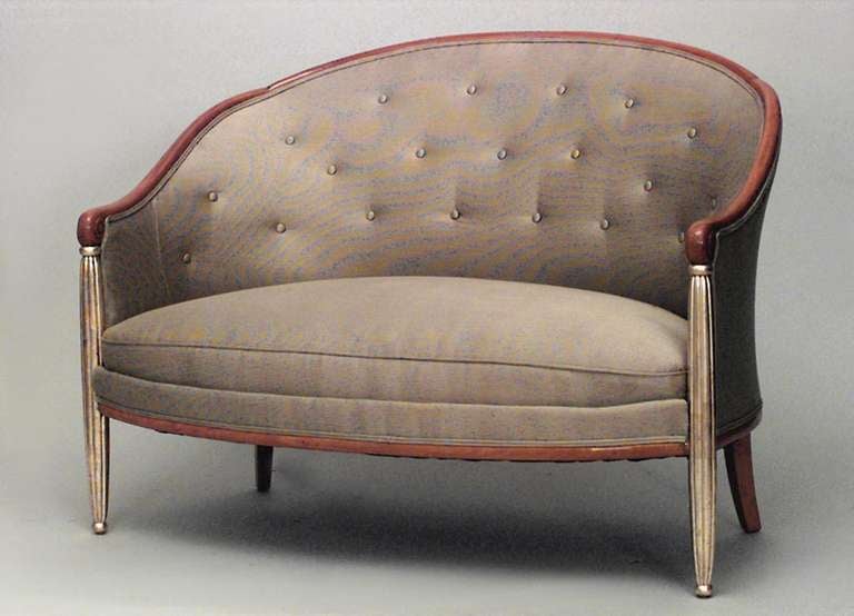 French Art Deco maple loveseat featuring gilt, fluted front legs as well as elegant button-tufted taupe upholstery.